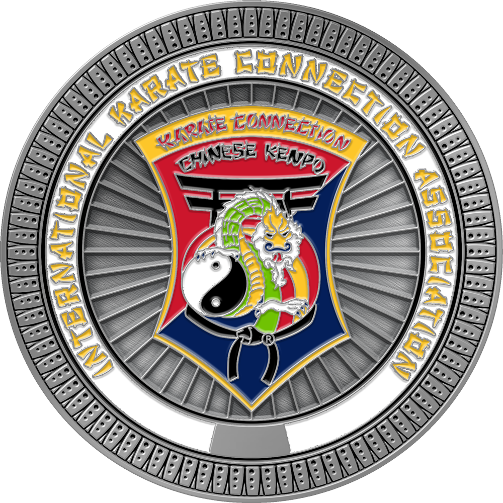 A circular metallic emblem or medallion for International Karate Connection Association Chinese Kenpo, featuring a silver outer ring, a central shield with a red and blue background, a green dragon, a white yin-yang symbol, and yellow lettering.