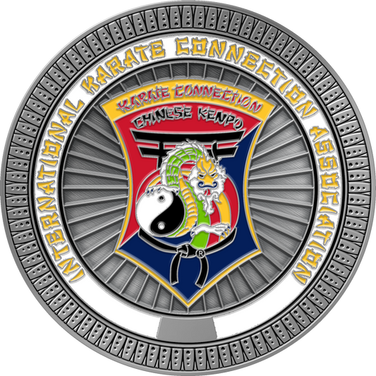 A circular metallic emblem or medallion for International Karate Connection Association Chinese Kenpo, featuring a silver outer ring, a central shield with a red and blue background, a green dragon, a white yin-yang symbol, and yellow lettering.
